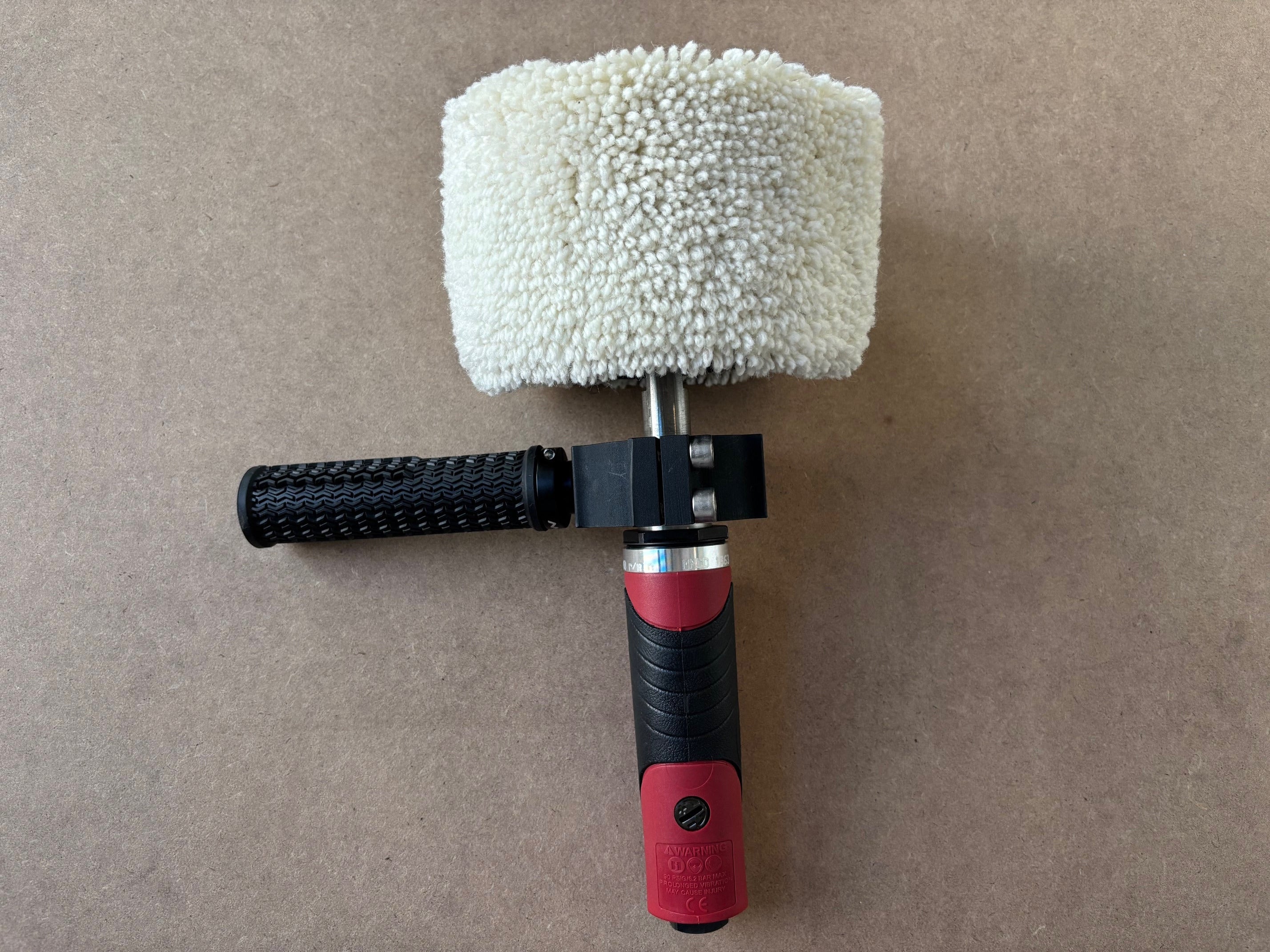 Lucid Aero Compact Drum Buffer front view with wool sleeve installed and Lucid Aero logo on mounting clamp