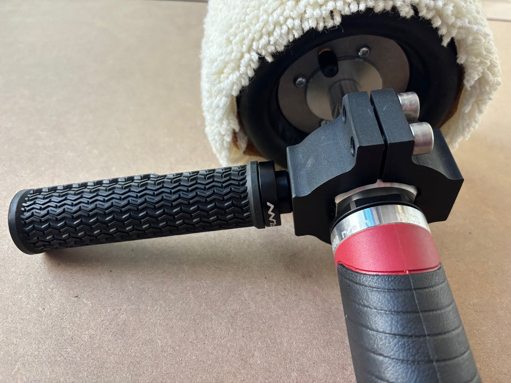 Close-up of Lucid Aero drum buffer grip handle and black anodized mounting clamp with drum hub spindle