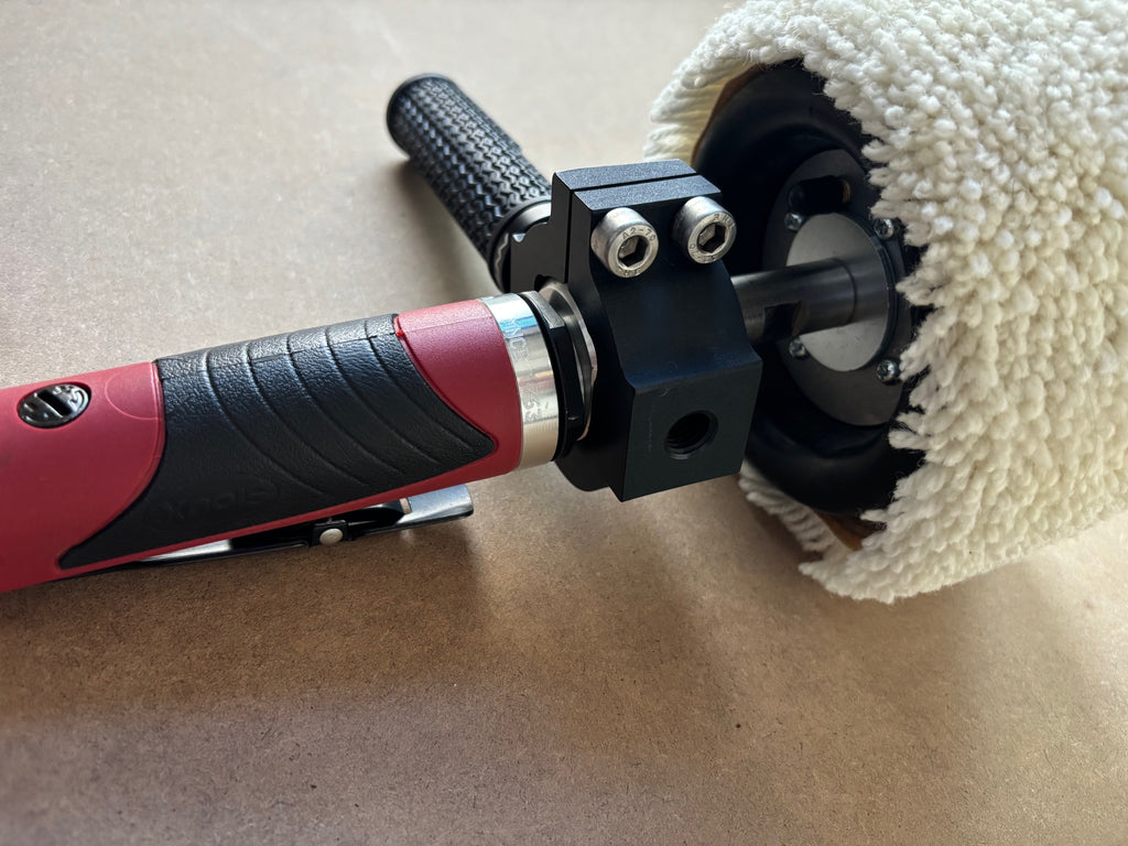 Lucid Aero drum buffer motor body and clamp block detail showing red pneumatic body, hex bolts, and sleeve mount