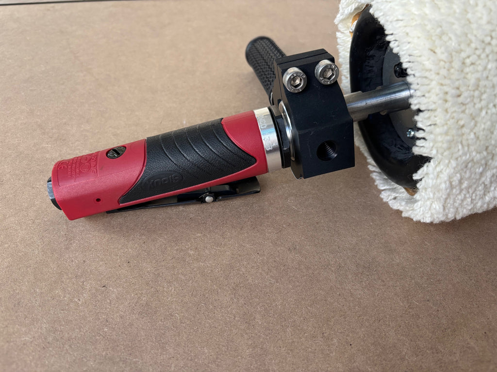 Lucid Aero drum buffer side profile showing red pneumatic motor body, throttle trigger, anodized clamp, and wool sleeve